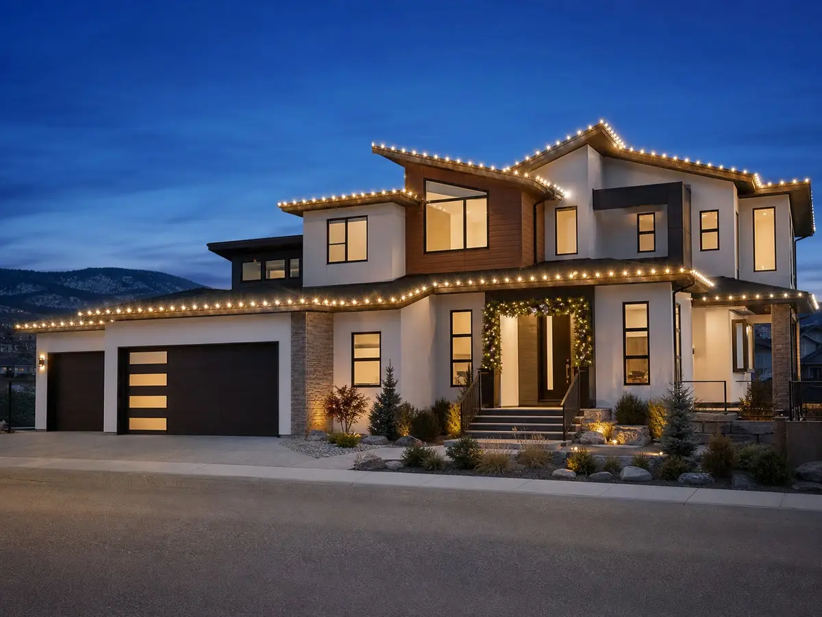 Modern Okanagan-style home with professionally spaced warm white Christmas lights