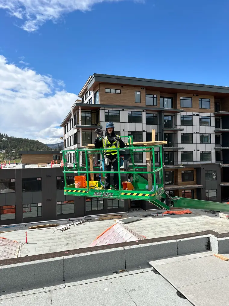 Beam's technician working from a lift at a multi-storey development