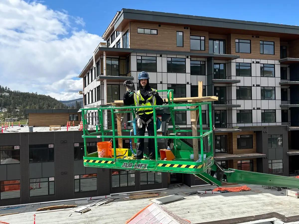 Beam's technician on a lift at a multi-storey strata window-cleaning project