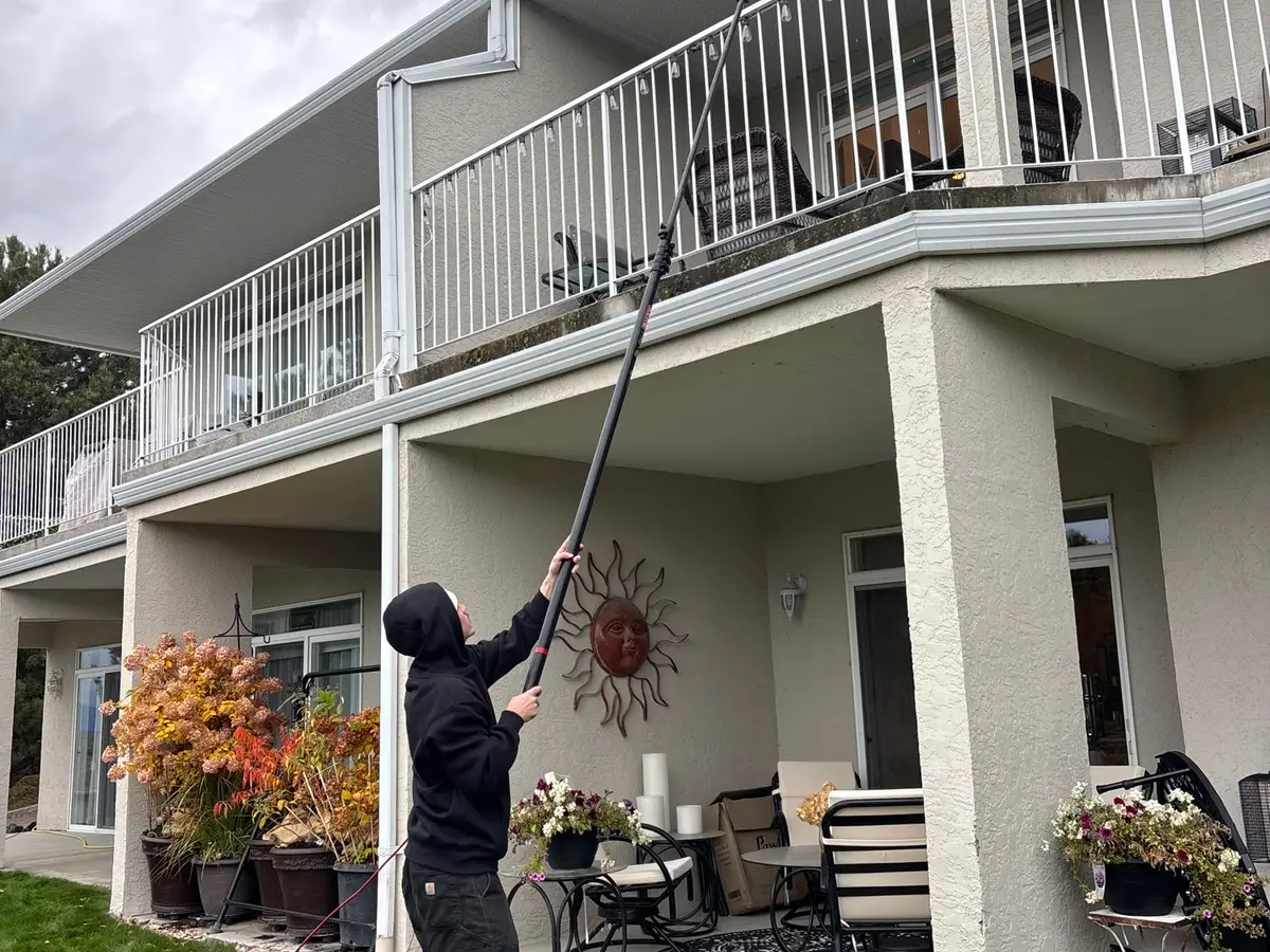 Beam's technician cleaning the gutter line of an Okanagan residence with an extension system