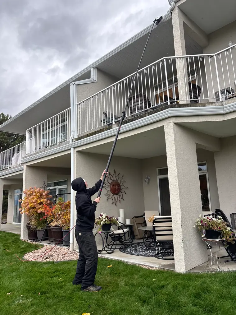 Beam's technician cleaning a residential gutter line with an extension system