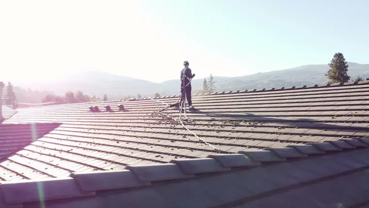 Beam's technician secured with fall protection while working on an Okanagan roof