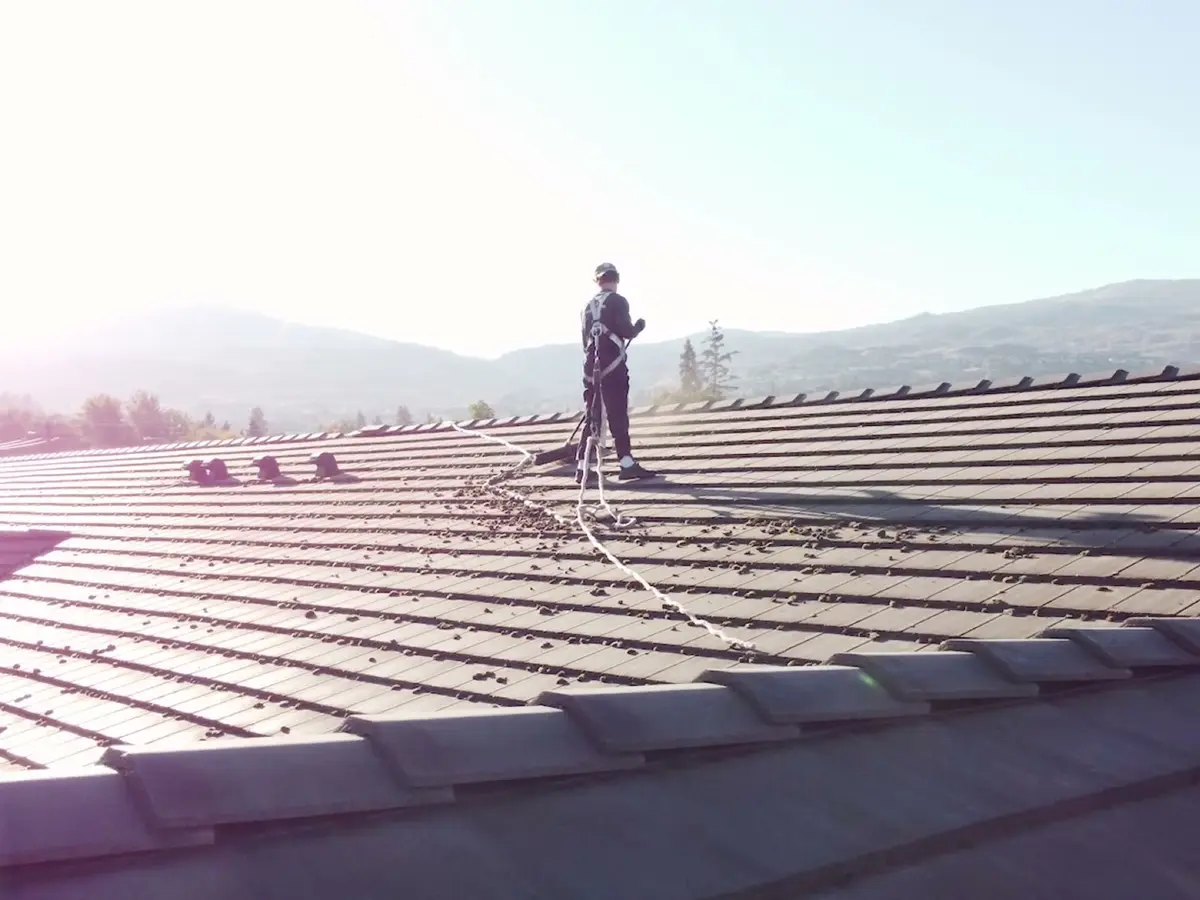 Beam's technician secured with fall protection while working on an Okanagan roof