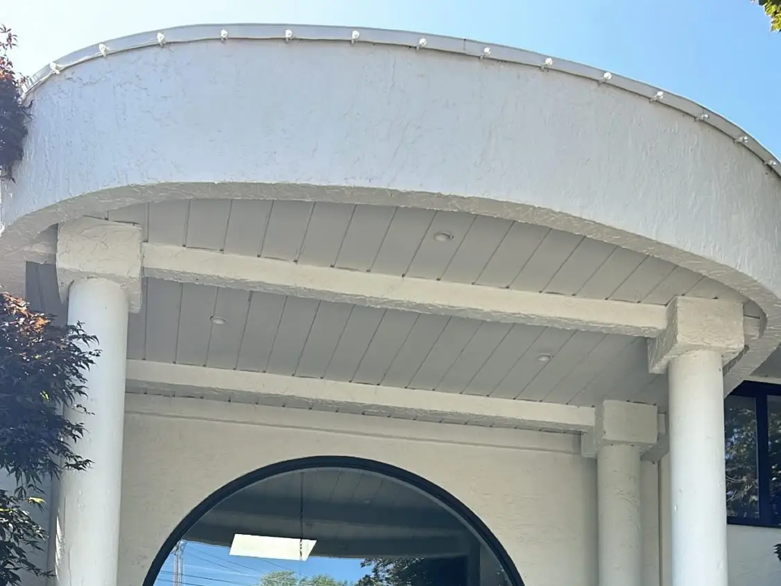 Lights installed along a curved residential roofline