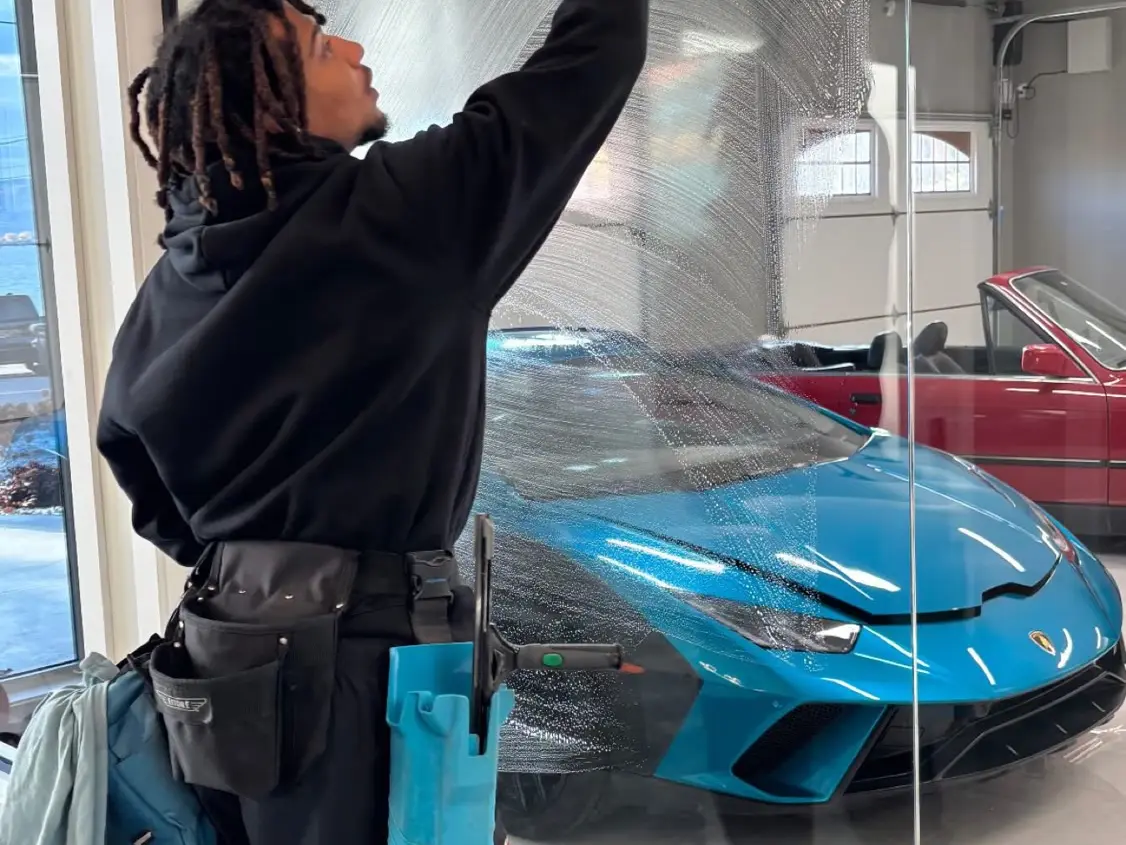 Beam's technician washing a large residential window by hand