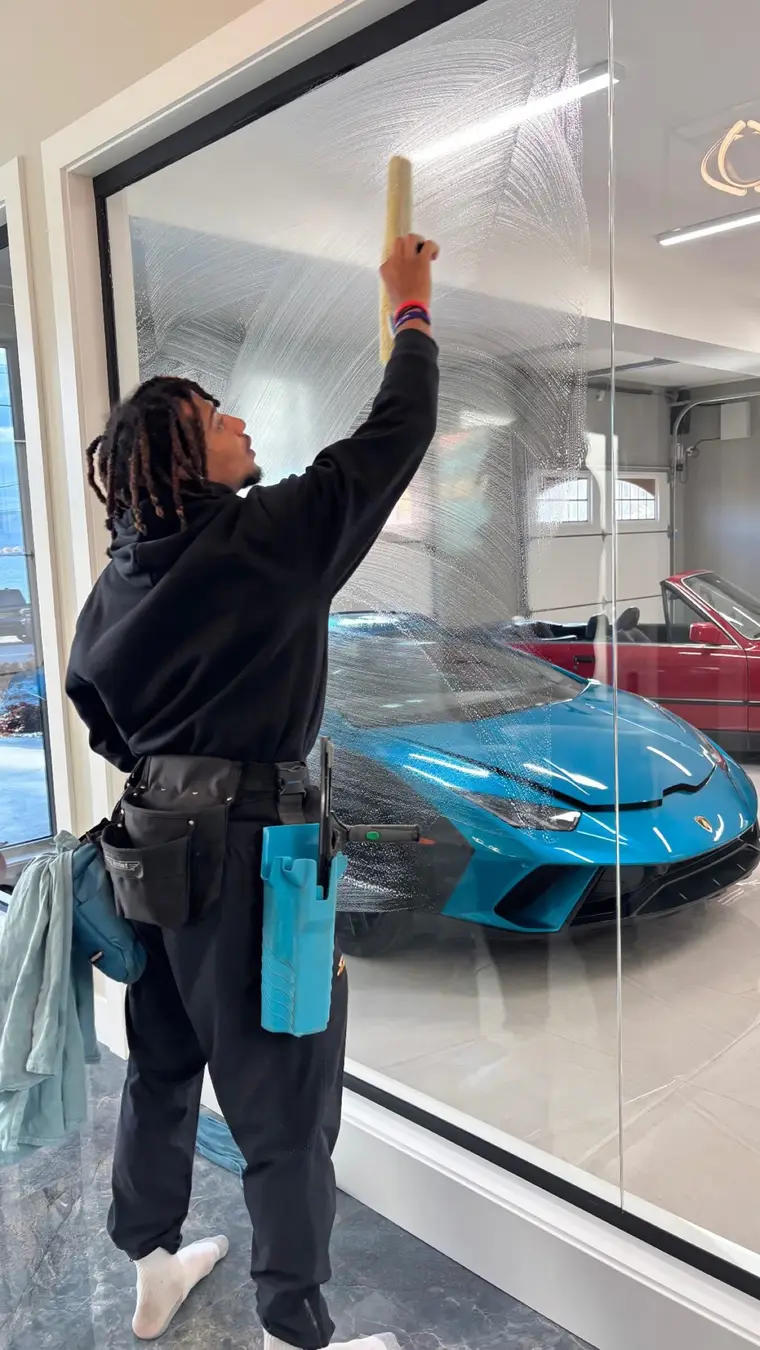 Beam's technician washing a large interior window